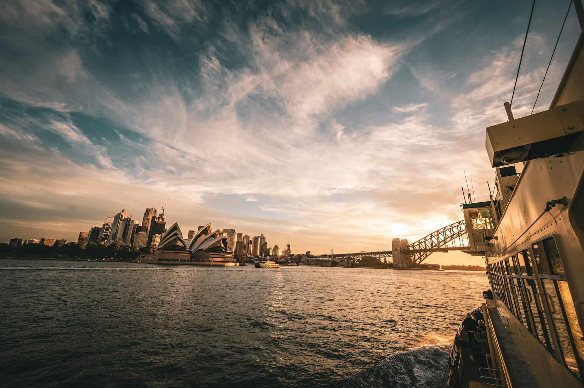 An image of golden hour over the city scape of Sydney overseeing the infamous opera dome.